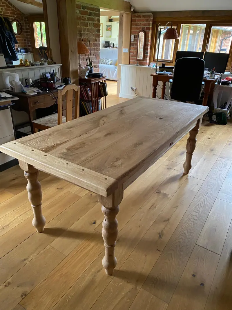 Oak dining table with turned legs in client home