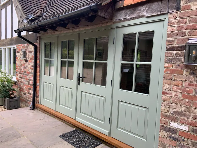 Painted french doors installed on period cottage